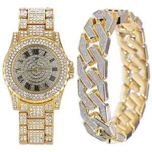 Close-up of gold iced out watch with Roman numerals and matching curb chain bracelet