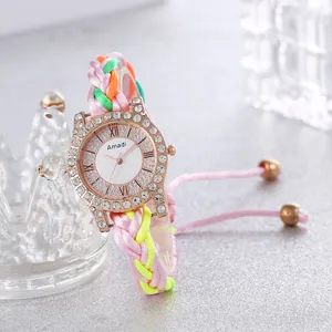 Bohemian women's watch with colorful woven strap and rhinestone bezel on grey background