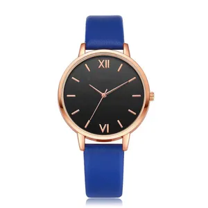 Macro shot of rose gold watch case with deep blue leather strap and Roman numerals dial