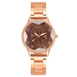 Detail of rose gold watch featuring floral dial with sunburst pattern and crystal bezel