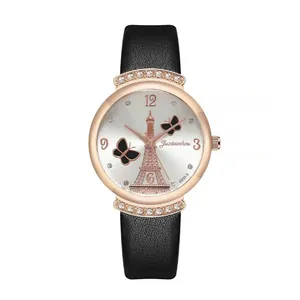 Close-up of silver dial with rose gold Eiffel Tower and butterfly motif on leather watch