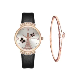 Detail of rose gold watch with Eiffel Tower dial and matching star pendant bracelet