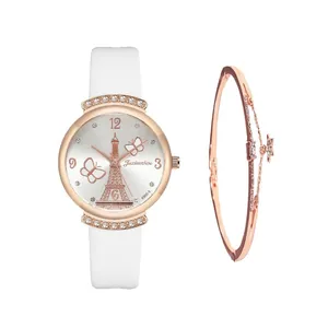 Detail of rose gold Eiffel Tower dial with crystal lugs and white leather strap