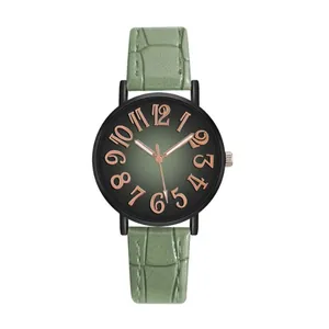 Close-up of green gradient dial with rose gold numerals and textured leather watch strap