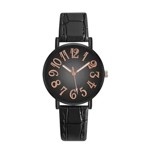 Detail of black leather watch strap with crocodile pattern and rose gold numerals