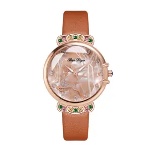 Close-up of mother-of-pearl watch dial with diamond deer and colorful gemstones
