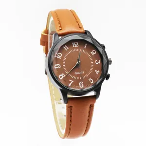 Retro quartz watch with brown leather strap and faceted glass over a wavy black dial