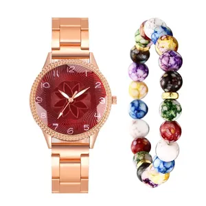 Close-up of rose gold watch with red floral dial and colorful marble bead bracelet set