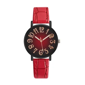 Macro detail of red crocodile leather strap and black gradient dial with gold numerals