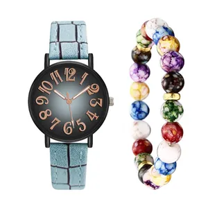 Detail of blue faux crocodile leather watch band and matching marbled beaded bracelet