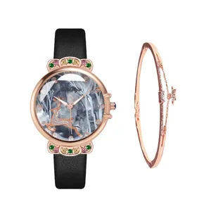 Detail of rose gold watch with deer dial, colorful crystals and matching star bracelet
