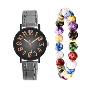 Detail of gray leather strap watch with black dial and colorful beaded bracelet set