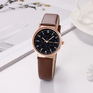 Detail der roségoldenen Uhr mit Sternenhimmel-Zifferblatt und braunem Lederarmband