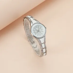 Elegant silver quartz watch with clover pattern and matching butterfly bracelet set