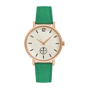 Detail view of emerald green frosted leather strap and rose gold quartz watch dial