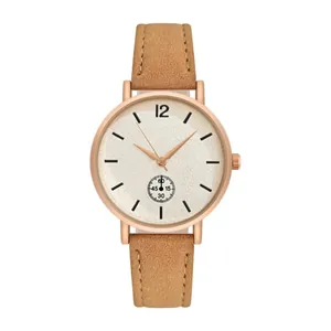 Detailed macro of the round white dial with rose gold case and brown frosted leather strap