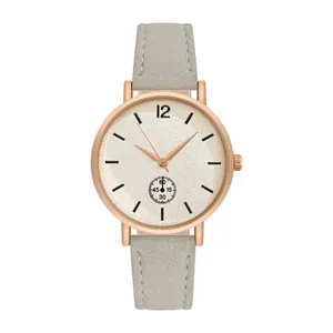 Close-up of minimalist rose gold watch with beige frosted dial and grey leather strap