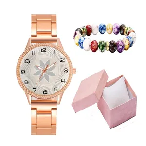 Detail of rose gold floral watch with colorful beaded bracelet and pink gift box set