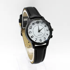 Detail view of quartz watch featuring black leather strap and textured numeric dial