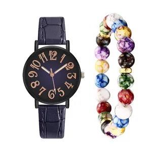 Detail of vintage ladies watch with navy crocodile leather strap and colorful bead bracelet