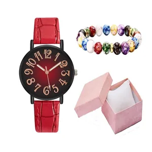 Close-up of red crocodile strap watch and stone bead bracelet in a pink gift box