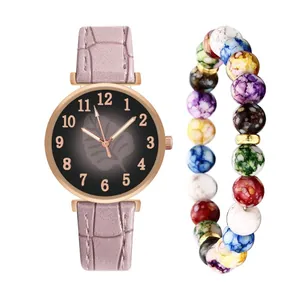 Detail of pink faux leather strap watch with numeric dial and colorful beaded bracelet