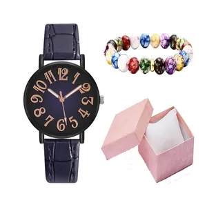 Close-up of women's quartz watch with blue leather strap and matching beaded bracelet in gift box