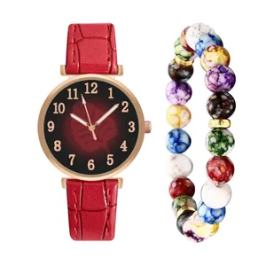 Close-up of women's quartz watch with red leather strap and matching colorful beaded bracelet