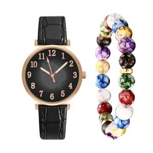 Detail of rose gold watch with leaf pattern and matching beaded bracelet on white base