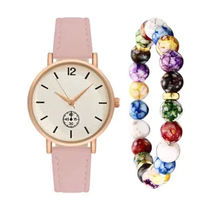 Detail of pink faux leather strap watch and colorful marbled bead bracelet set
