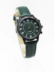Detail of dark green quartz watch with wave pattern dial and faceted black case