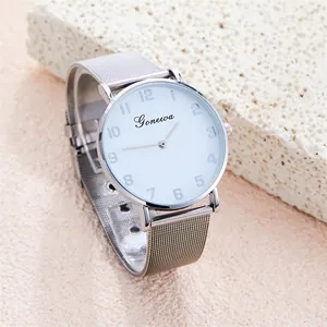 Macro view of minimalist silver mesh strap watch with clean white dial and numeral markers