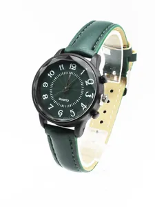 Close-up of a minimalist green quartz watch with dark matte case and leather strap