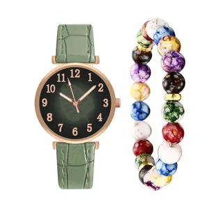 Women's quartz watch with leaf pattern dial and colorful beaded bracelet set on white background