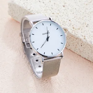 Macro detail of minimalist silver mesh watch strap on natural stone background