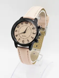 Detail of pink faux leather strap and black matte case on a minimalist quartz watch