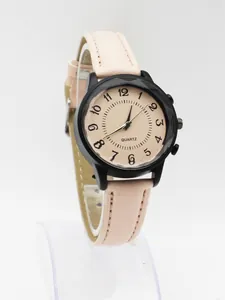 Close-up of women's quartz watch featuring a black geometric case and beige dial