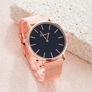 Close-up of Geneva rose gold mesh band watch with matte black dial on stone