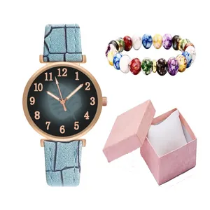 Detail of light blue leather watch with rose gold case and jewelry box set