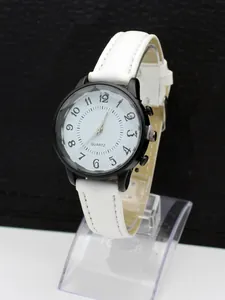 Detail view of quartz watch with wavy texture dial and faceted glass lens