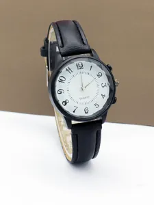Detail view of the black case watch with white ripple dial and large Arabic numerals