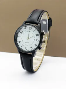 Close-up of women's quartz watch showing black leather strap and textured dial face