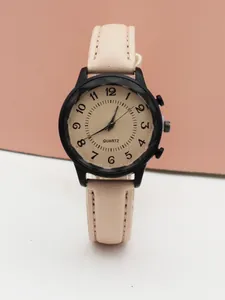 Detail of pink leather watch strap with fine stitching and black matte alloy case