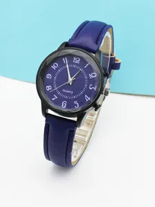 Detailed macro view of deep blue quartz watch face with white Arabic numerals