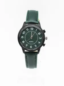 Macro detail of the dark green textured watch dial with white numerals and black casing