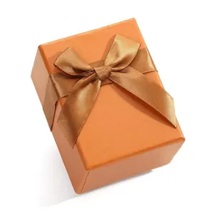 Caja de regalo para joyas de cuero PU naranja con lazo de cinta decorativo a juego