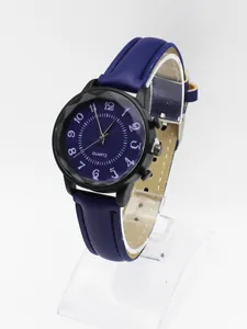 Detail of blue leather strap watch with black casing and white Arabic numerals