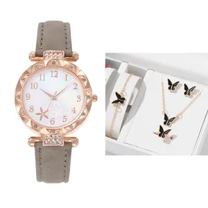 Close-up of women's quartz watch and black butterfly jewelry set in a luxury gift box