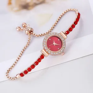 Detail of rhinestone bezel watch with red crystals and adjustable sliding gold buckle