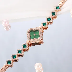 Detailed macro shot of rose gold lucky clover watch with green dial and crystals